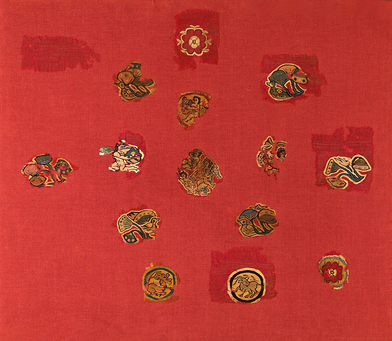 Antinoe, Egypt, Fragments from the Shawl of Sabina: Nile and rural scenes with Cupids, ducks, boars and flowers. Red woollen cloth with woven decoration in wool and linen Acquisition, 2014 E 33148